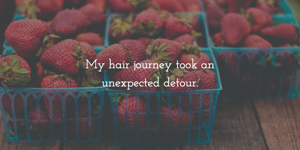 Baskets of strawberries with the text: My hair journey took an unexpected detour.